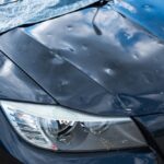 Auto s preliačinami na kapote po krupobití počas jarných búrok.